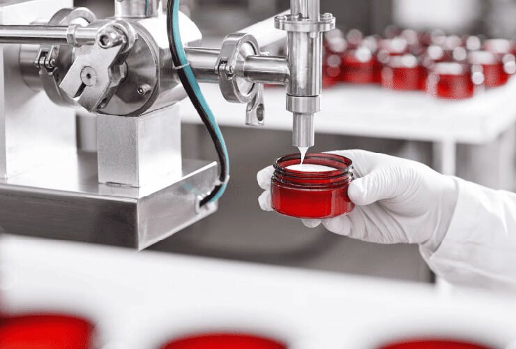 Laboratory instrument dispensing a red liquid sample